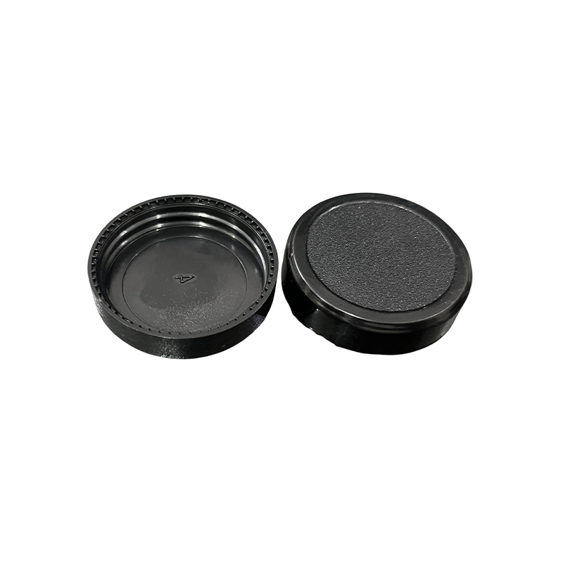 Finished jar caps showing knurled thread and textured top surface